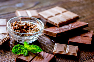 black and milk chocolate bars dark wooden table background
