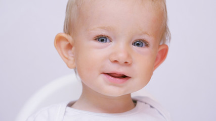 Portrait of cute happy child with blue eyes and blonde hair