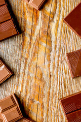 black and milk chocolate bars dark wooden table background top view mockup