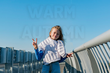 Little girl posing on the bridge