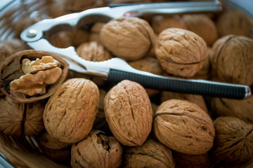 Nutcracker on brown walnuts. Whole walnuts