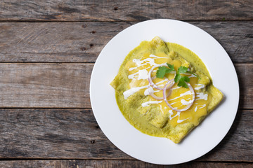 Mexican green enchiladas with melted cheese also called 