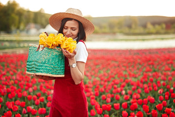 Happy woman smelling flowers in field