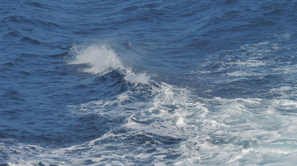 Naklejka na ściany i meble Sea waves splashing, middle of blue whirlpool