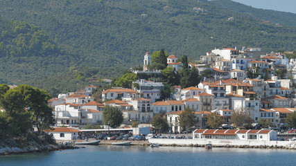 Fototapeta na wymiar Passing near Greek island, paradise place with green trees, sailing on blue sea