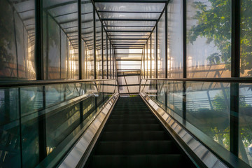 An escalator in a glass box
