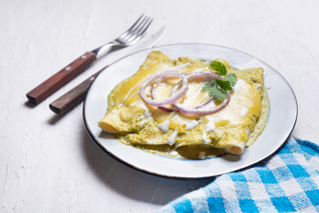 Mexican green enchiladas with melted cheese also called 