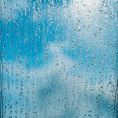 heavy rain drops on blue window