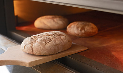 Bread on spade near hot oven