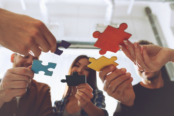 Teamwork of partners. Concept of integration and startup with puzzle pieces
