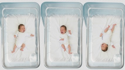 Funny babies moving hands and legs in hospital beds, newborn activity