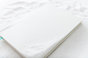 White Leather Book or Planner on White Sand with Zen Lines