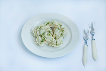Dumplings with potatoes on a white plate. White background . Traditional dish of Ukraine.