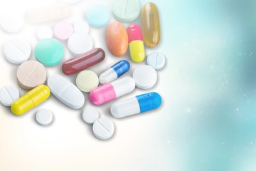Colorful pills and tablets on background
