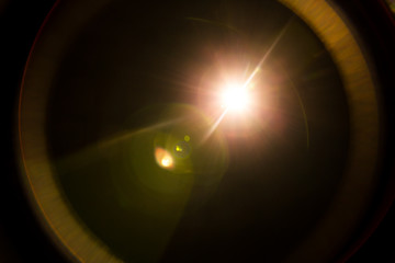 abstract lens flare red light over black background