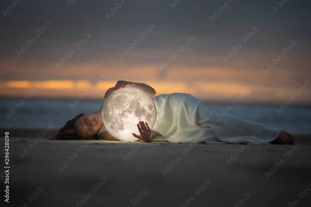 Wall mural astrology. secret and riddle. beautiful attractive girl on a night beach with sand hugs the moon, ar