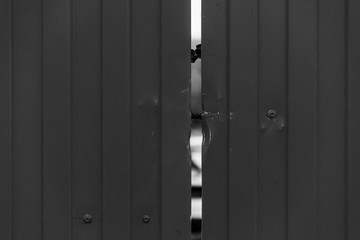 Black and white corrugated metal fence