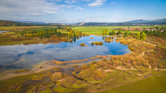 Aerial drone view of amazing autumn colors on the lake. Cerknisko lake, Slovenia