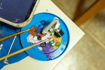 palette with paints and brushes