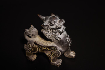 Fototapeta na wymiar sculpture figurine dragon metal at background