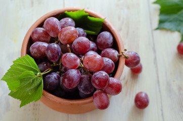 Beautiful red grapes are in the bowl.