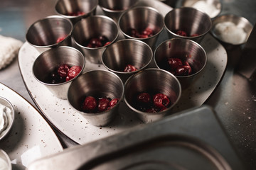 gray iron containers in which the cherry lies