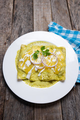 Mexican green enchiladas with melted cheese also called 