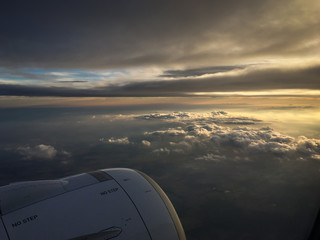 View of the sky and clouds from the airplane porthole. jet engine turbine look through aircraft window