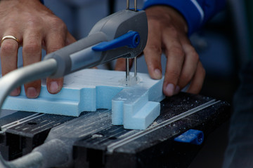 Hands of a male carpenter making a workpiece on a joiner's machine