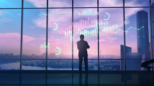 Businessman in office considers holographic infographic.