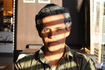 Mysterious handsome man with shadows on his face