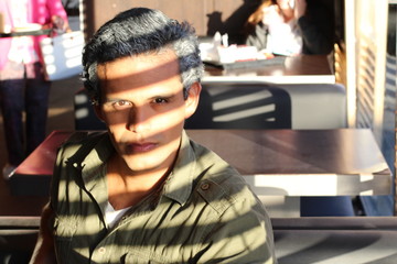 Mysterious attractive ethnic man at a bar
