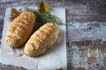 Delicious fresh homemade bread. Italian bread with herbs. Selective focus. Macro.
