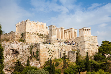 Fototapeta premium Tourists visiting the Acropolis in a beautiful early spring day seen from the Areopagus Hill in Athens