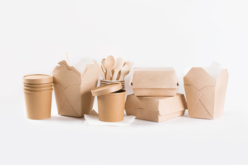 Eco kraft paper tableware. Paper cups, dishes, fast food containers and wooden cutlery on white...