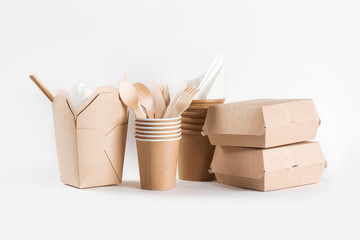 Eco craft paper tableware. Paper cups, dishes, fast food containers and wooden cutlery on white...