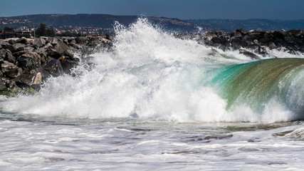 Big wave rolling towards the shore on Balboa Peninsula, CA.