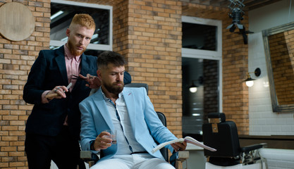 Barber - Shaves and Trims. Great time at barbershop. Barber Shop Studios. Barber scissors and...