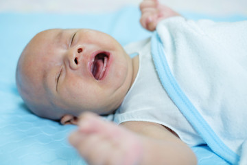 Newborn crying baby boy.