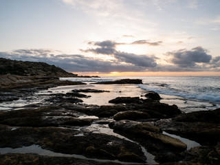 Fototapeta na wymiar Rocky beach by the sea at dawn in Cabo de Huertas Alicante