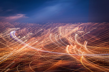Lightpainting from intentional camera movement in the window showing night city lights