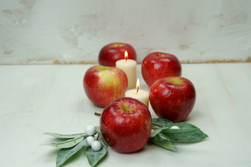 Red apples with candles and leaves.