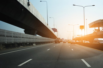 Car driving on high way road at sunset,Cars on the stretched road and The road leading to the eye,Car on road