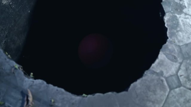 Creepy red balloon in dark sewage drain, symbol of danger, evil clown trap