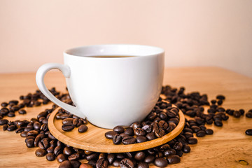 Coffee in white cup on wooden table in coffee shop