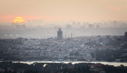 Sunset over Istanbul Silhouette. City landscape with modern buildings and bosphorus.