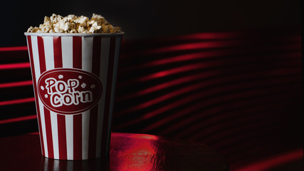 food background of big cup or bucket of popcorn to eat as snack in cinema theatre