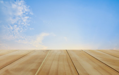 Wooden table and blue sky background montage for your texture concept or design