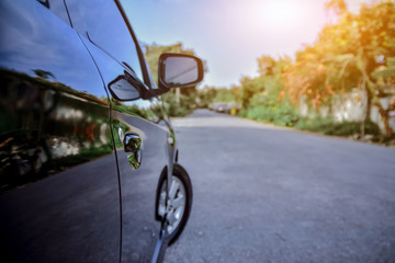 Car parked on street,Car on road and sunset background,Tire of car on road