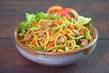 Noodles : Vegetarian stir fried noodle with tofu, carrots and green vegetables. Chinese vegetarian noodle for vegetarian festival.
